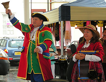 Colourful town crier with bell