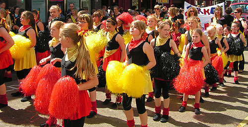 red black and yellow pom-poms