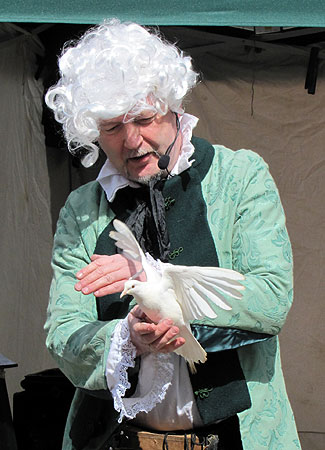 Magician produces white dove