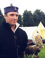 A falconer with a barn owl