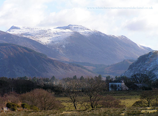 house and snow capped fells