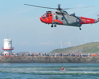 Royal Navy Seaking lifts man from water