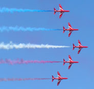 Red Arrows - V formation with coloured trails
