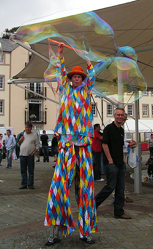 Clown on Stilts blowing bubbles