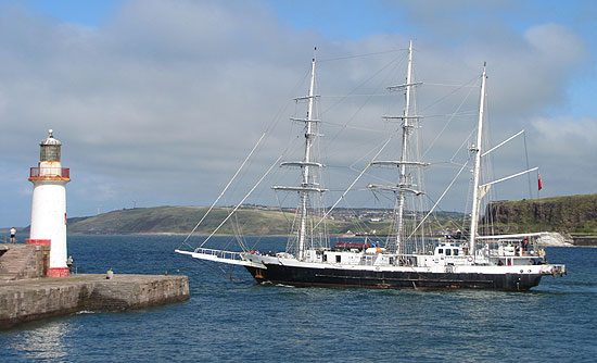 Tall Ship Lord Nelson leaving Whitehaven harbour past the lighthouse