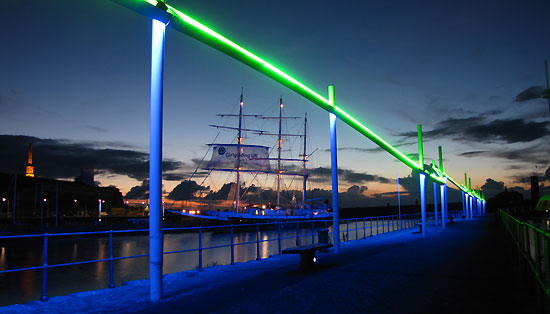 Neon Wave Scupture framing the Lord Nelson at night