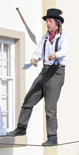 Juggling knives balancing on wire