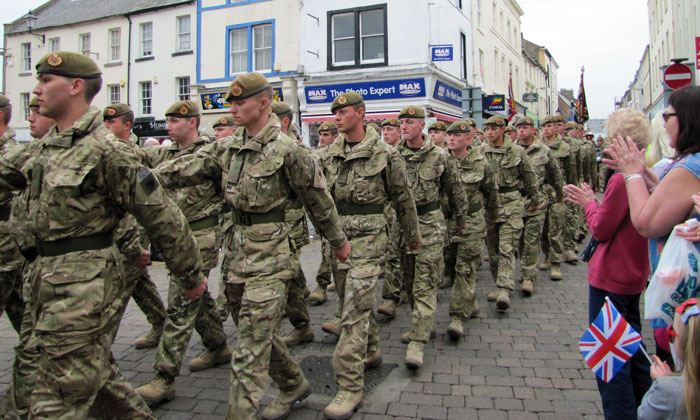 Troops in combat fatigues marching around Whitehaven