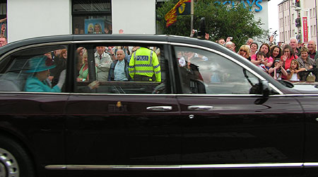 Queen waving in the royal car